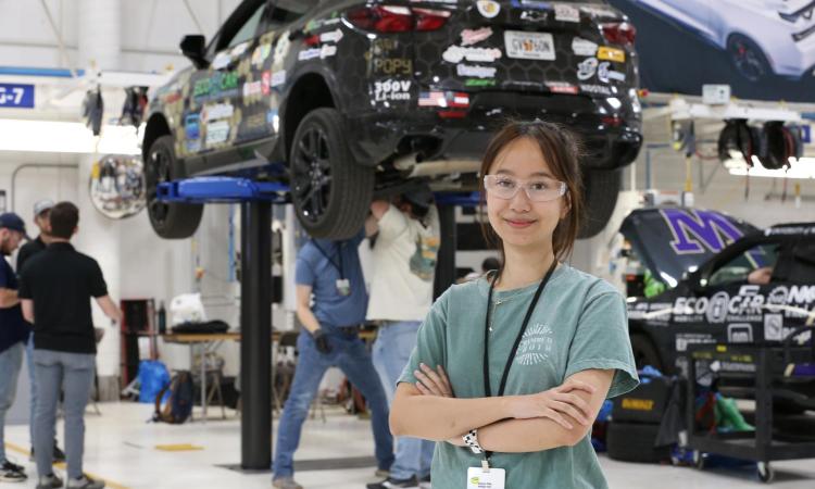 Georgia Tech student stands in front of EcoCAR project. 