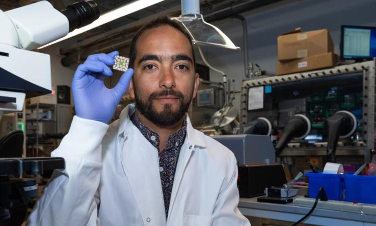 Juan-Pablo Correa-Baena in a lab holding a chip