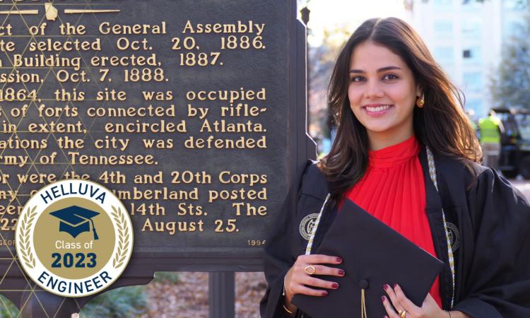 Nicole Proudfoot stands by the Georgia Tech historical marker with a "Helluva Engineer - Class of 2023" graphic overlay
