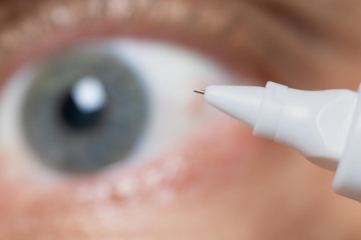 a closeup image of a microneedle displayed in front of an eye