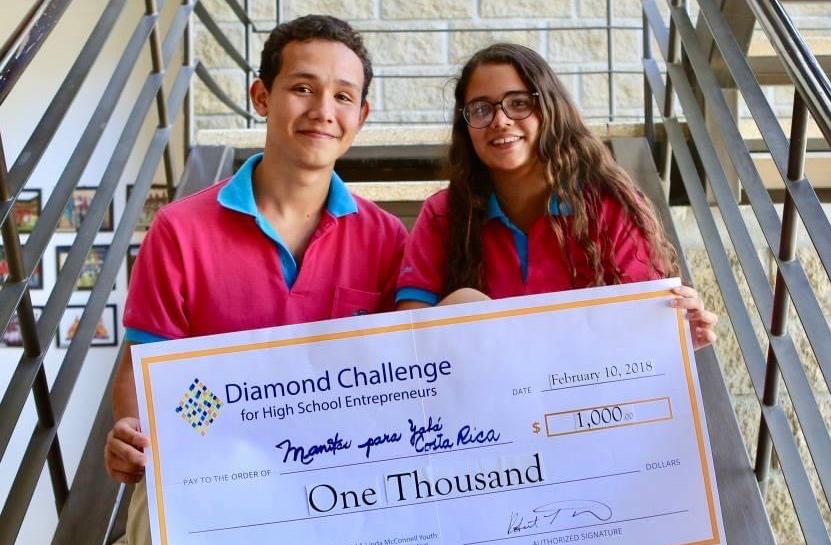 Nicole Proudfoot and a high school classmate with a winner's check