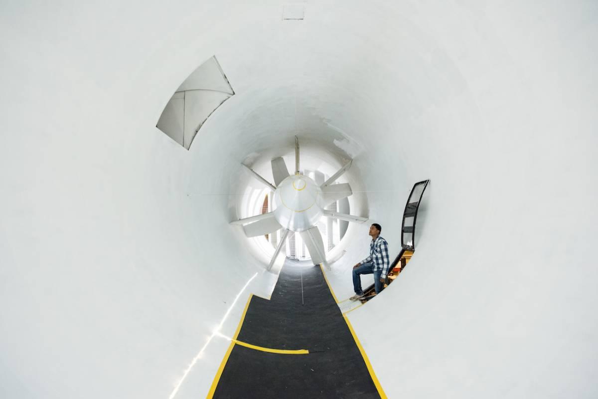 A student inspects the low-speed wind tunnel, a state-of-the-art facility for experimental research.