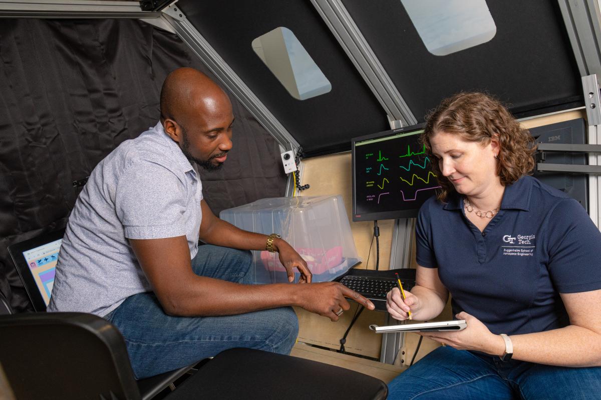 Karen Feigh and a student gather data in a medevac simulation