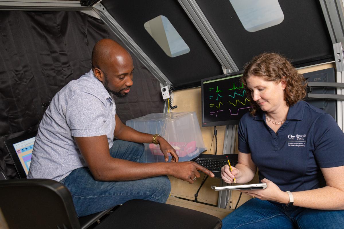 Karen Feigh and a student gather data in a medevac simulation