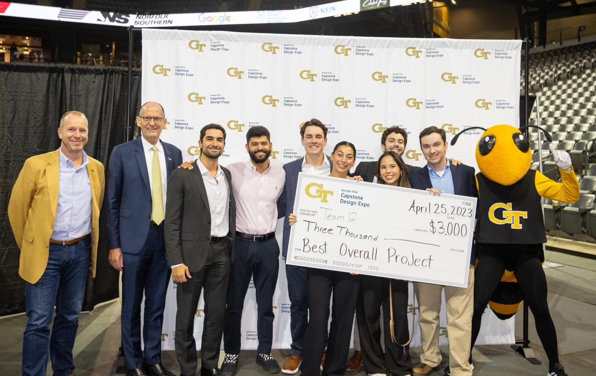 group of winning students and faculty with oversized check and Buzz mascot