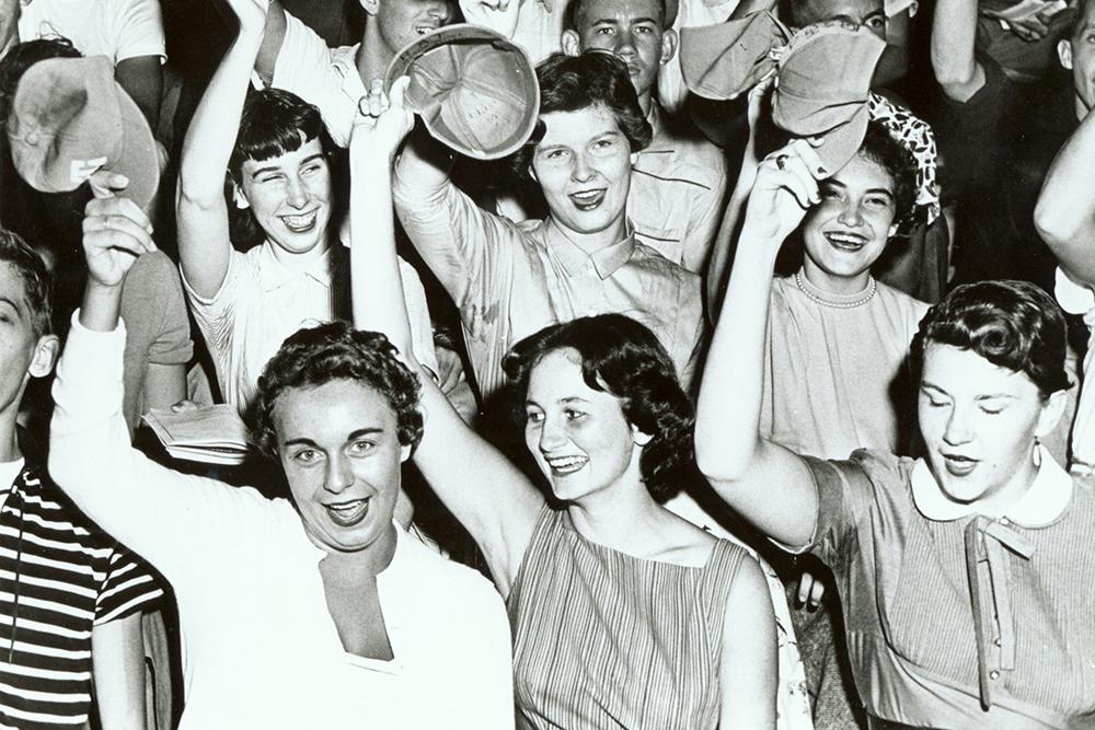Some of the first female students at Tech wave their RAT caps in the air alongside other first-year students. (Photo: Georgia Tech Library Archives)