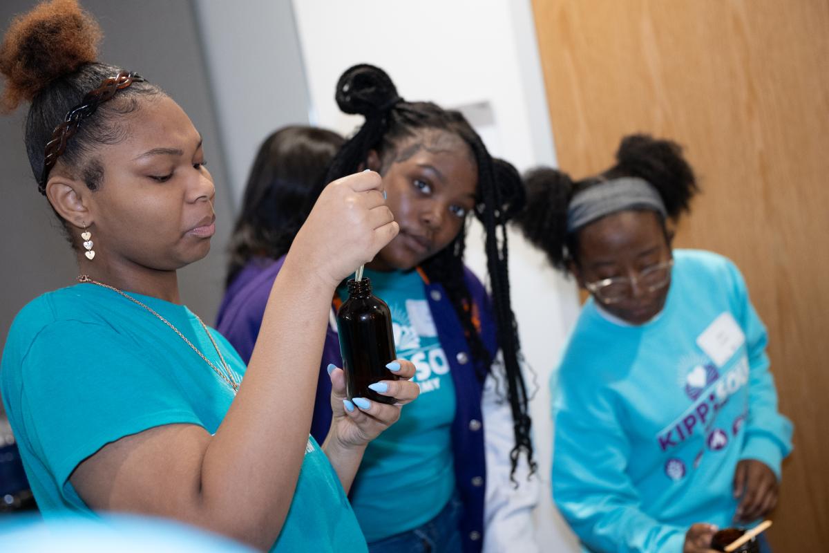 WIE student removing liquid from bottle with syringe